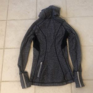 Gray Lululemon top with black trim and hood.